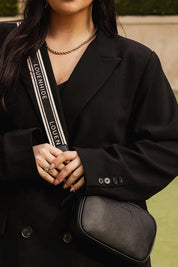 A model wearing the Bianca Crossbody Bag in colour Black (Black), from the front, showing the whole outfit