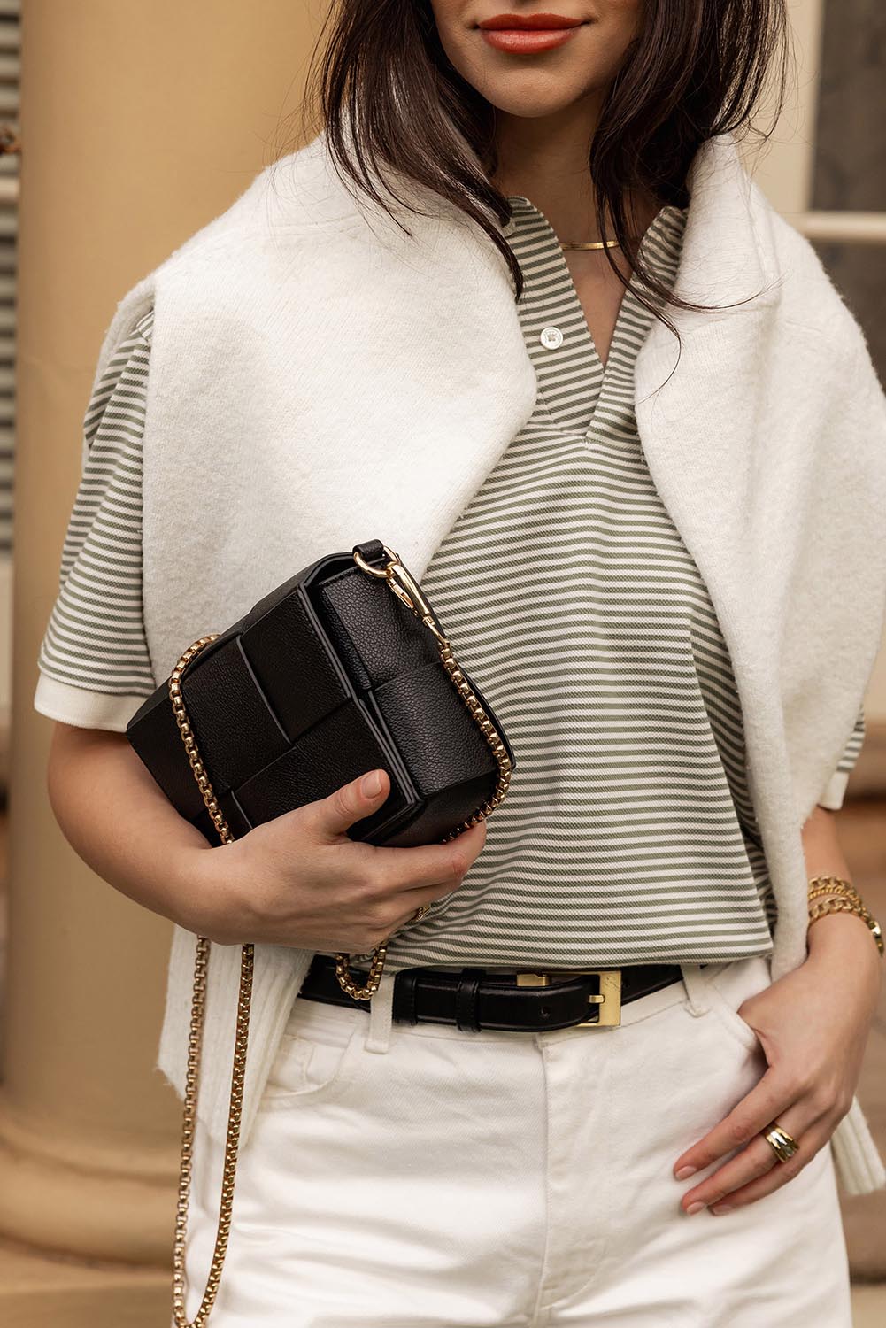 A model wearing the Josephine Day Night Crossbody Bag in colour Black (Black), from the front, showing the whole outfit