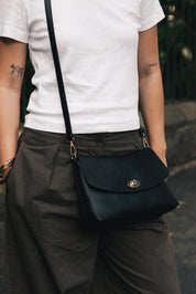 Product shot of the Nisha Shoulder Bag - Black in colour Black, from the back