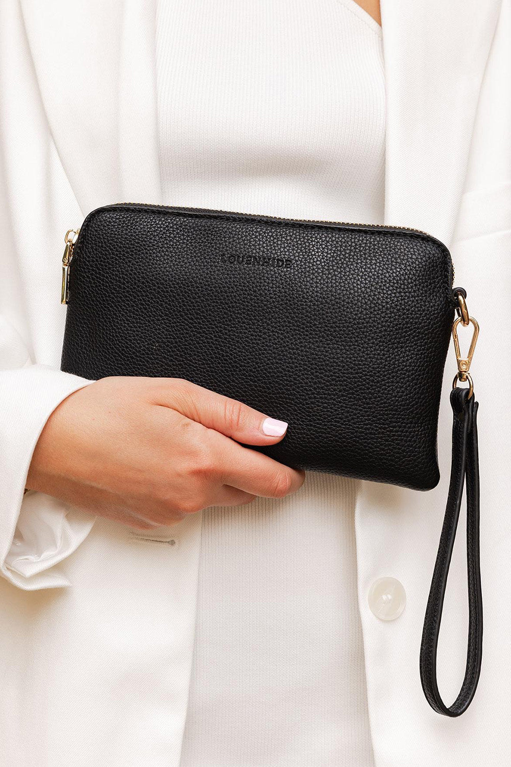 A model wearing the Poppy Clutch in colour Black (Black), from the front, showing the whole outfit