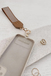 A model wearing the Iris Keyring With Phone Attachment in colour Camel, from the front, showing the whole outfit