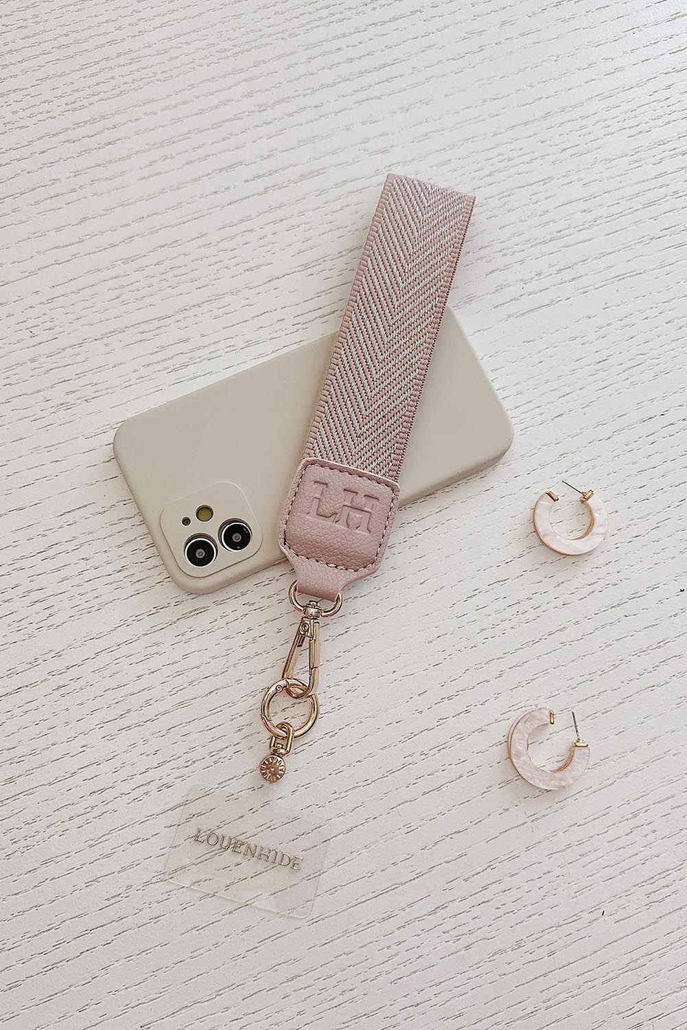 A model wearing the Iris Keyring With Phone Attachment in colour Duskypink (Pink), from the front, showing the whole outfit