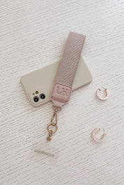 A model wearing the Iris Keyring With Phone Attachment in colour Duskypink (Pink), from the front, showing the whole outfit