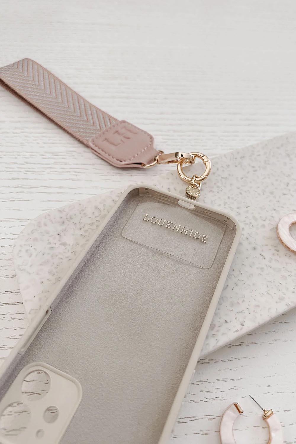A model wearing the Iris Keyring With Phone Attachment in colour Duskypink (Pink), from the front, showing the whole outfit