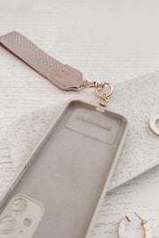 A model wearing the Iris Keyring With Phone Attachment in colour Duskypink (Pink), from the front, showing the whole outfit