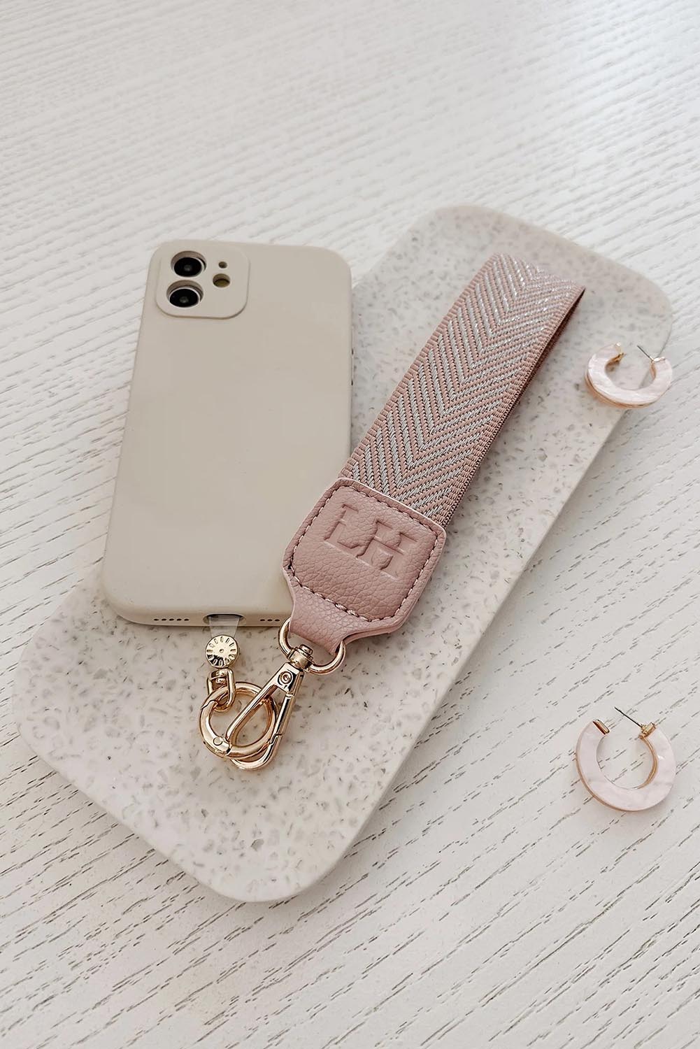 A model wearing the Iris Keyring With Phone Attachment in colour Duskypink (Pink), from the front, showing the whole outfit
