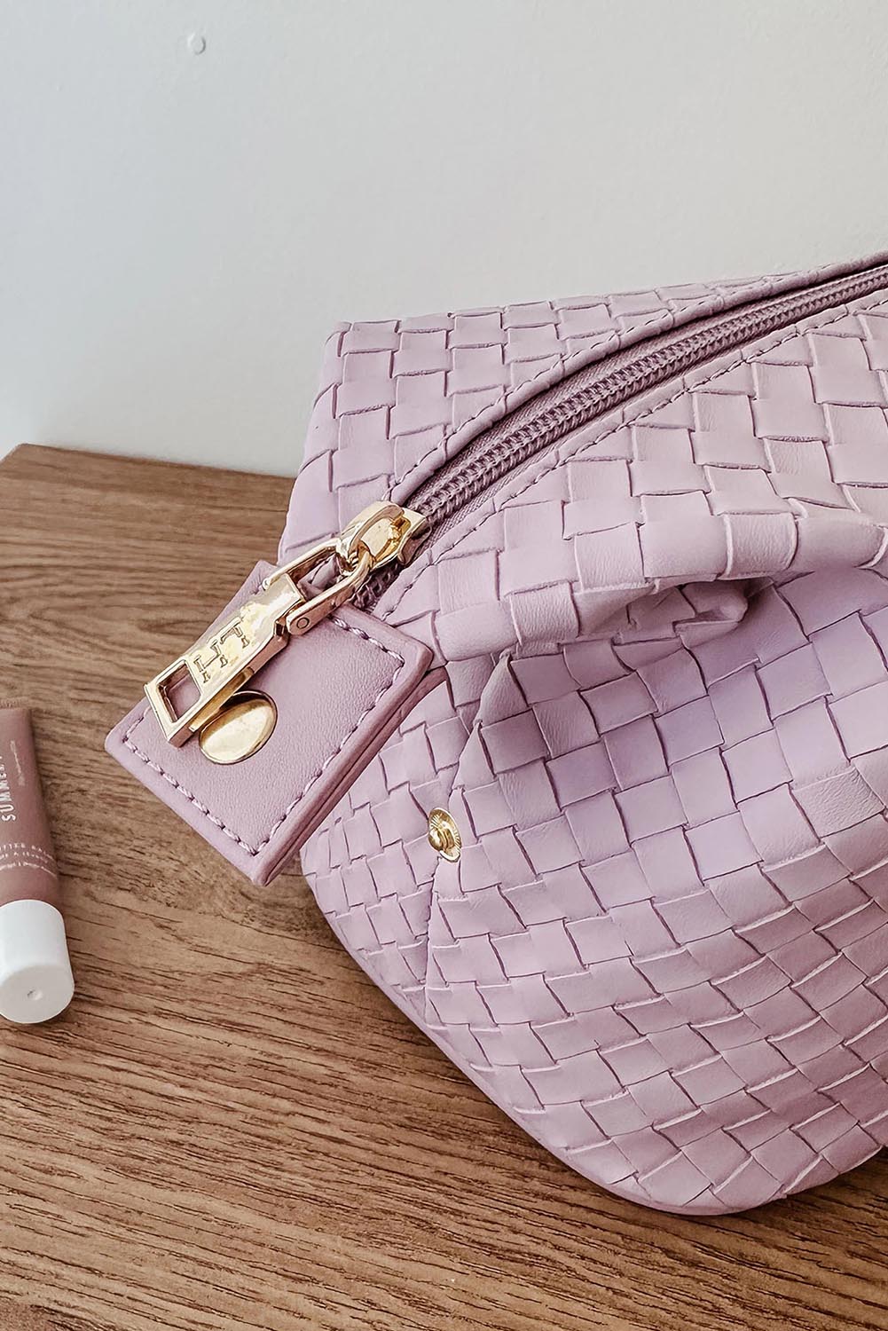 A model wearing the Lucinda Woven Toiletries Bag in colour Lilac (Purple), from the front, showing the whole outfit