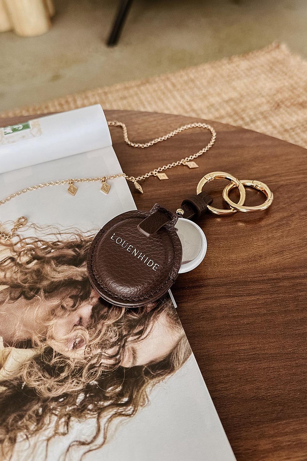 A model wearing the Opal Airtag Holder in colour Chocolate, from the front, showing the whole outfit