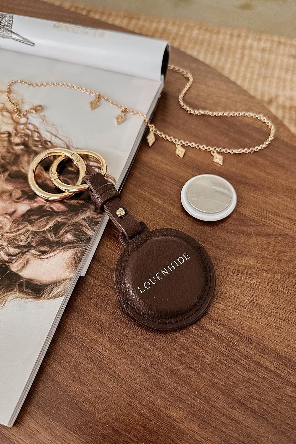 A model wearing the Opal Airtag Holder in colour Chocolate, from the front, showing the whole outfit