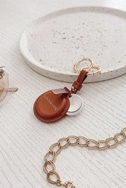 A model wearing the Opal Airtag Holder in colour Tan, from the front, showing the whole outfit