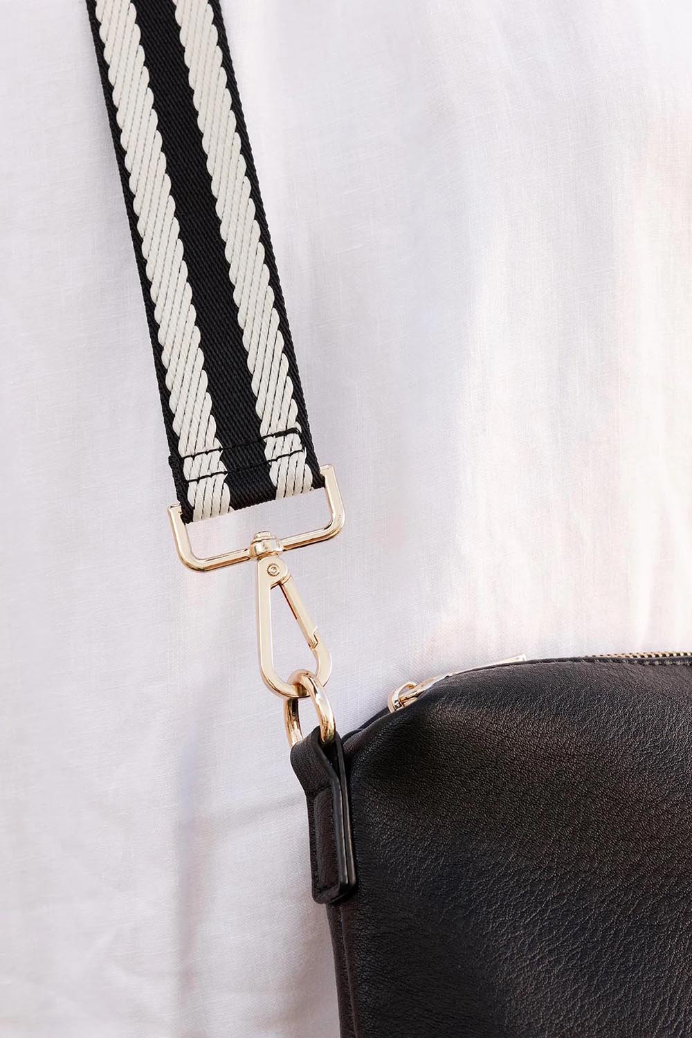 A model wearing the Bag Strap in colour Blackwhite (Black), from the front, showing the whole outfit