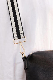 A model wearing the Bag Strap in colour Blackwhite (Black), from the front, showing the whole outfit