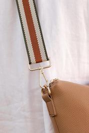 A model wearing the Bag Strap in colour Tangreen, from the front, showing the whole outfit