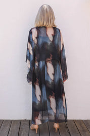 Model Sandy wearing the Silk Blend Cape Dress in colour Nero (Blue), from the back