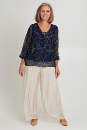 Model Sandy wearing the Silk Blend Vin colourNeck Tied Top - Navyflower (Blue), from the front, showing the whole outfit