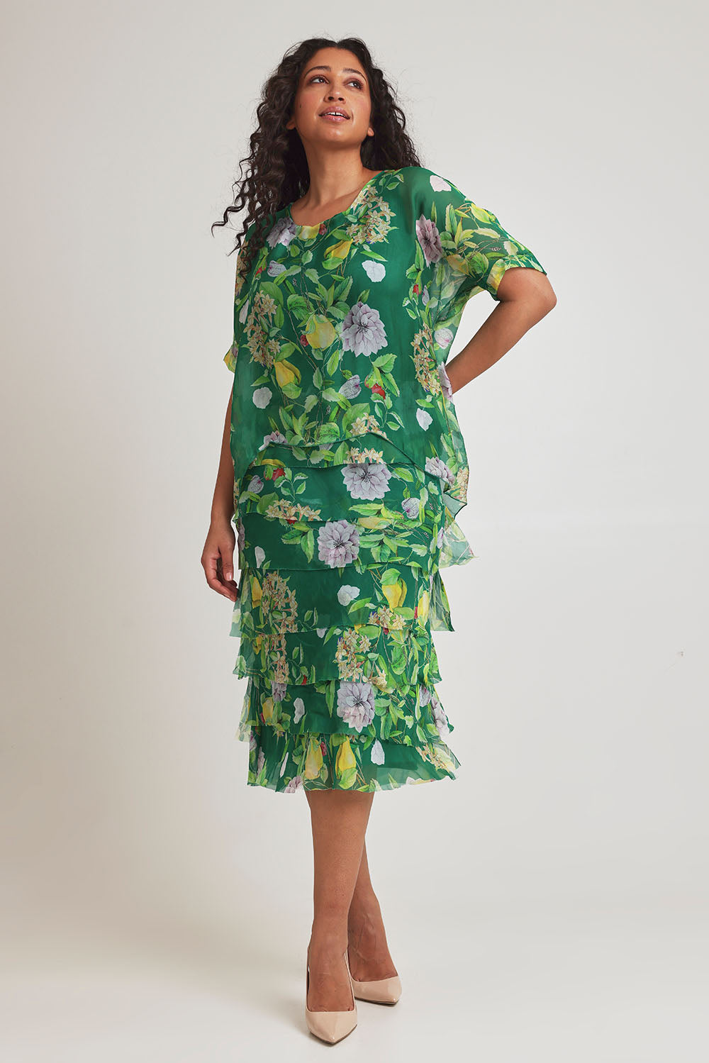 Model Terri-Leigh wearing size L of the Overlay Silk Print Dress in colour Greenflora (Green), from the front, showing the whole outfit