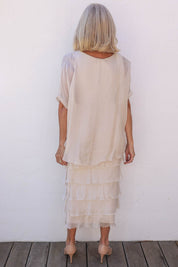 Model Sandy wearing the Silk Blend Multi Layers Dress in colour Champagne (White), from the back