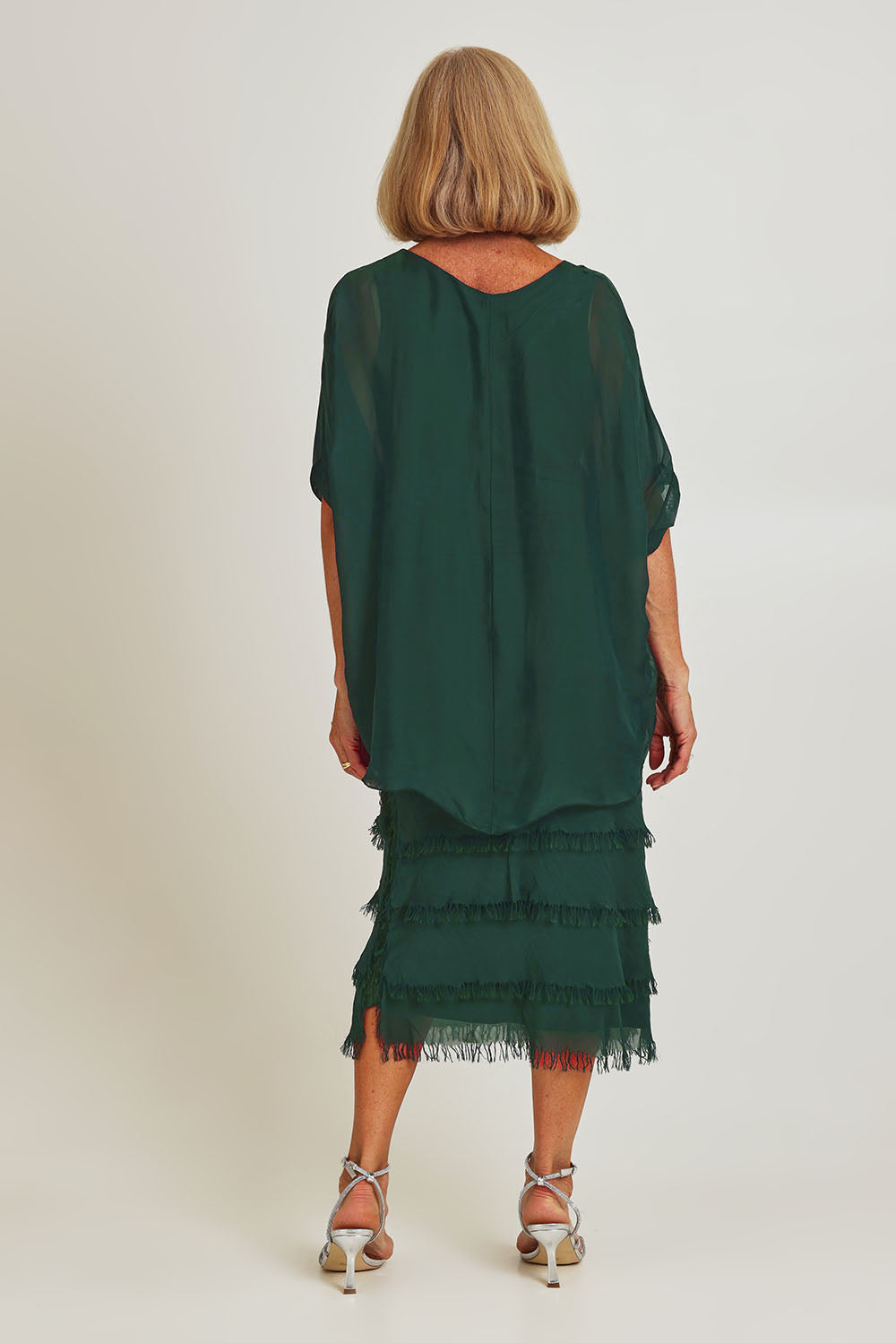 Model Sandy wearing the Silk Blend Multi Layers Dress in colour Darkgreen (Green), from the back