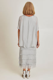 Model Sandy wearing the Silk Blend Multi Layers Dress in colour Grigio (Grey), from the back