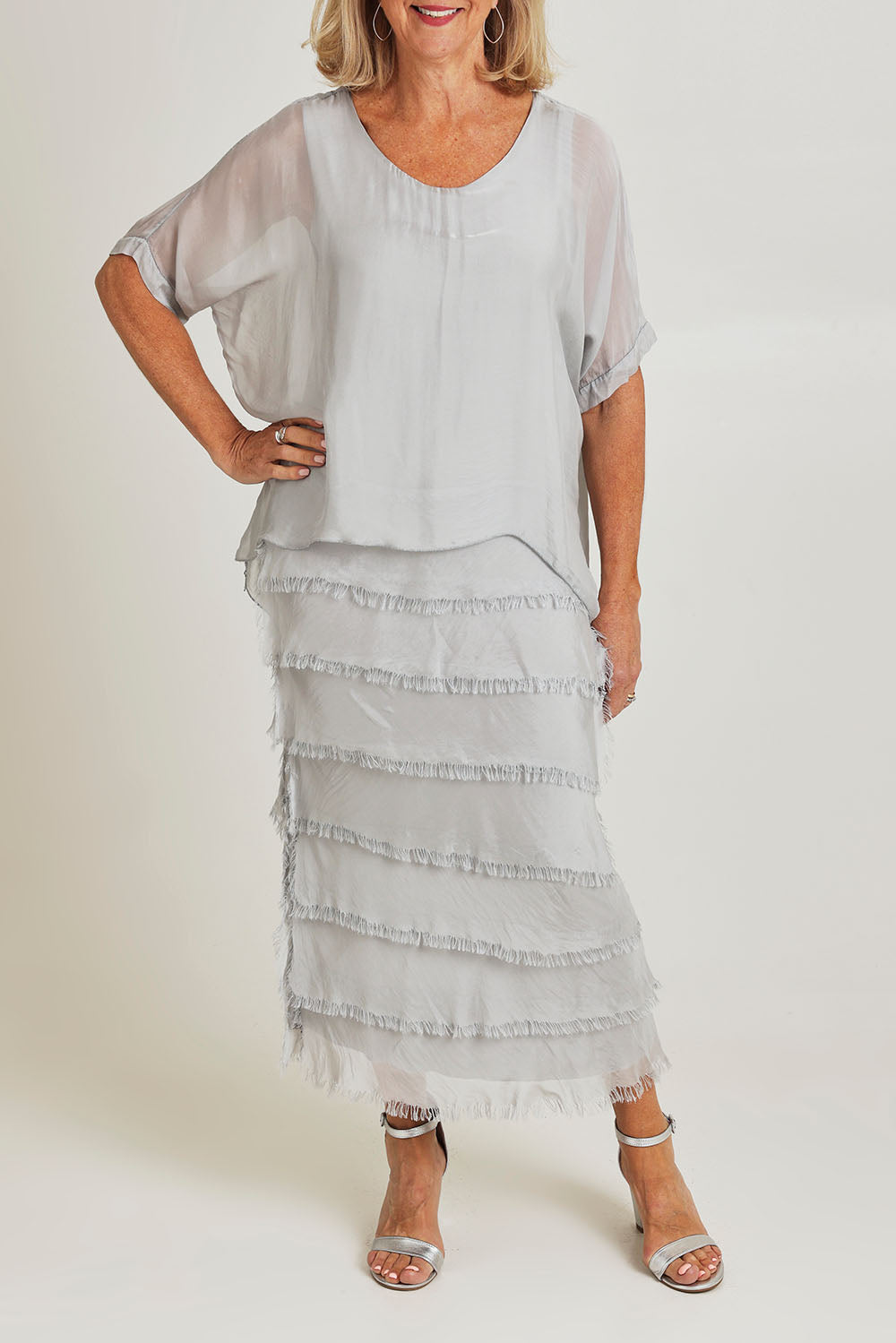 Model Sandy wearing the Silk Blend Multi Layers Dress in colour Grigio (Grey), from the front, cropped image