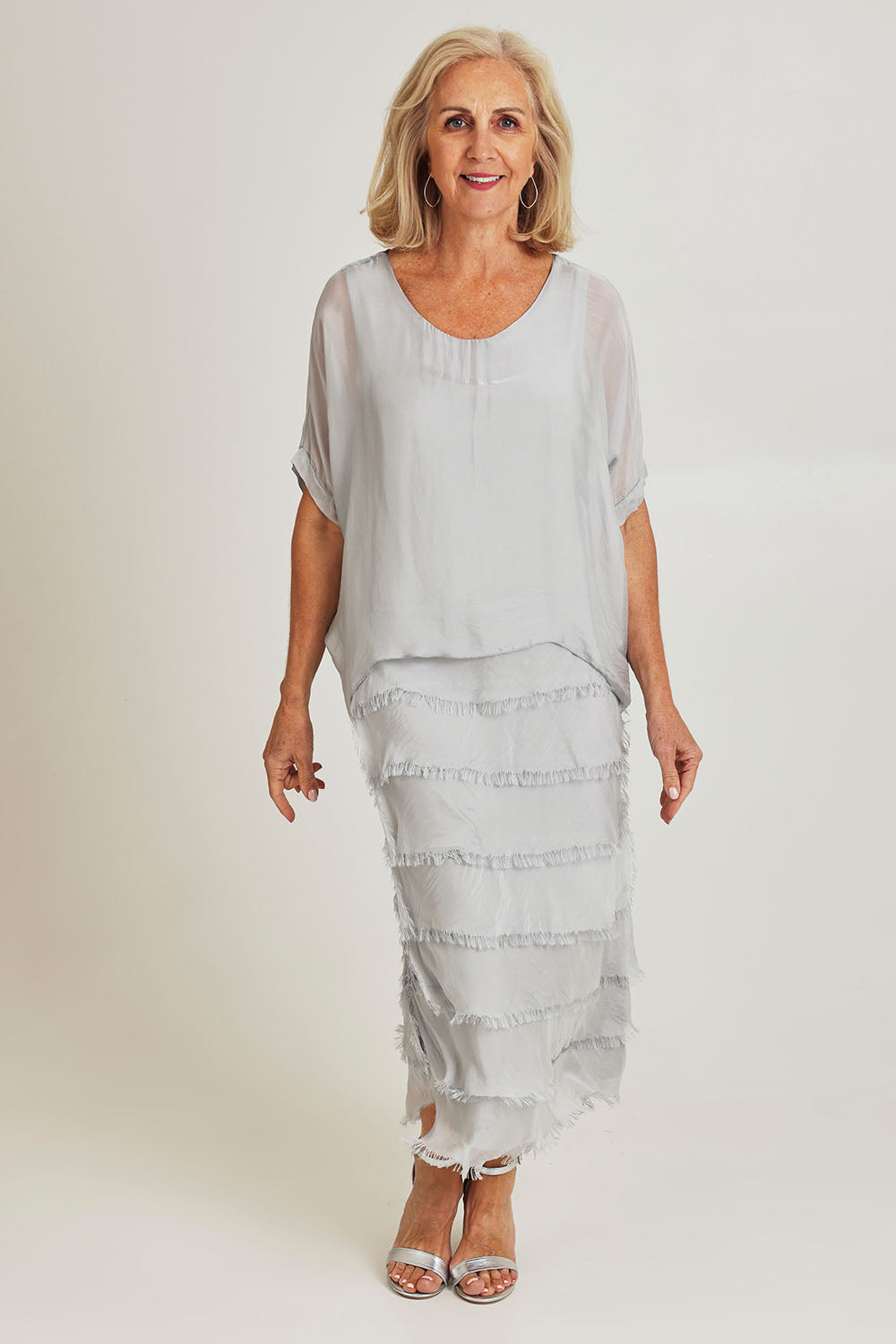 Model Sandy wearing the Silk Blend Multi Layers Dress in colour Grigio (Grey), from the front, showing the whole outfit