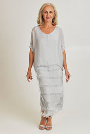 Model Sandy wearing the Silk Blend Multi Layers Dress in colour Grigio (Grey), from the front, showing the whole outfit