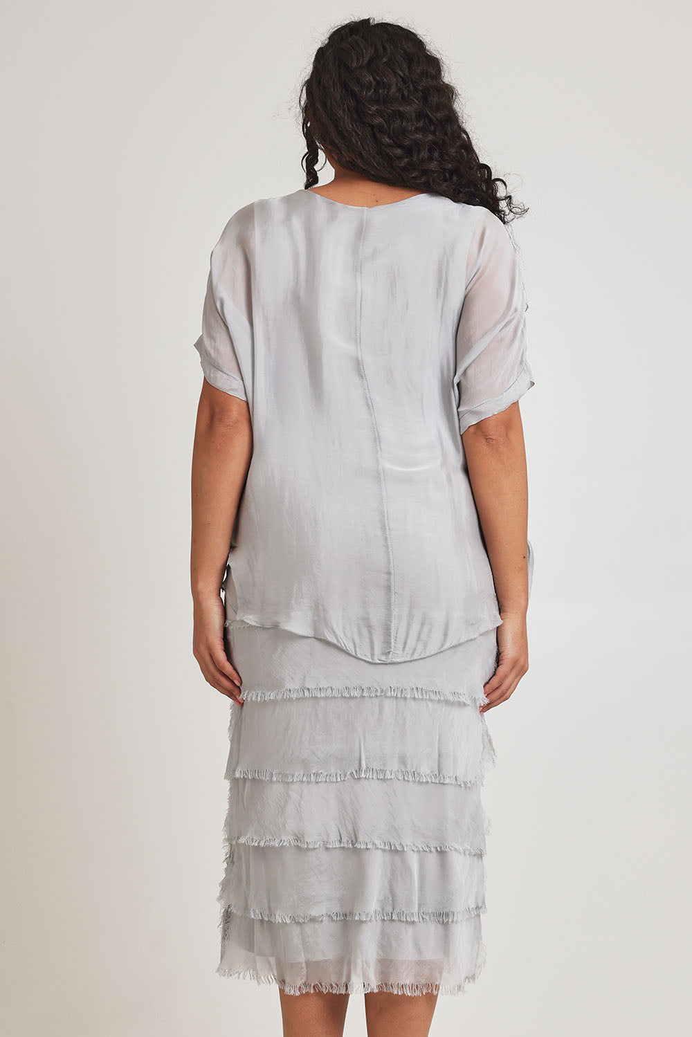 Model Terri-Leigh wearing the Silk Blend Multi Layers Dress in colour Grigio (Grey), from the back
