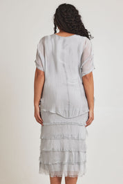 Model Terri-Leigh wearing the Silk Blend Multi Layers Dress in colour Grigio (Grey), from the back