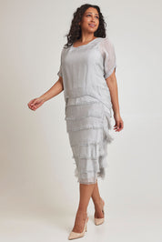 Model Terri-Leigh wearing the Silk Blend Multi Layers Dress in colour Grigio (Grey), from the front, showing the whole outfit