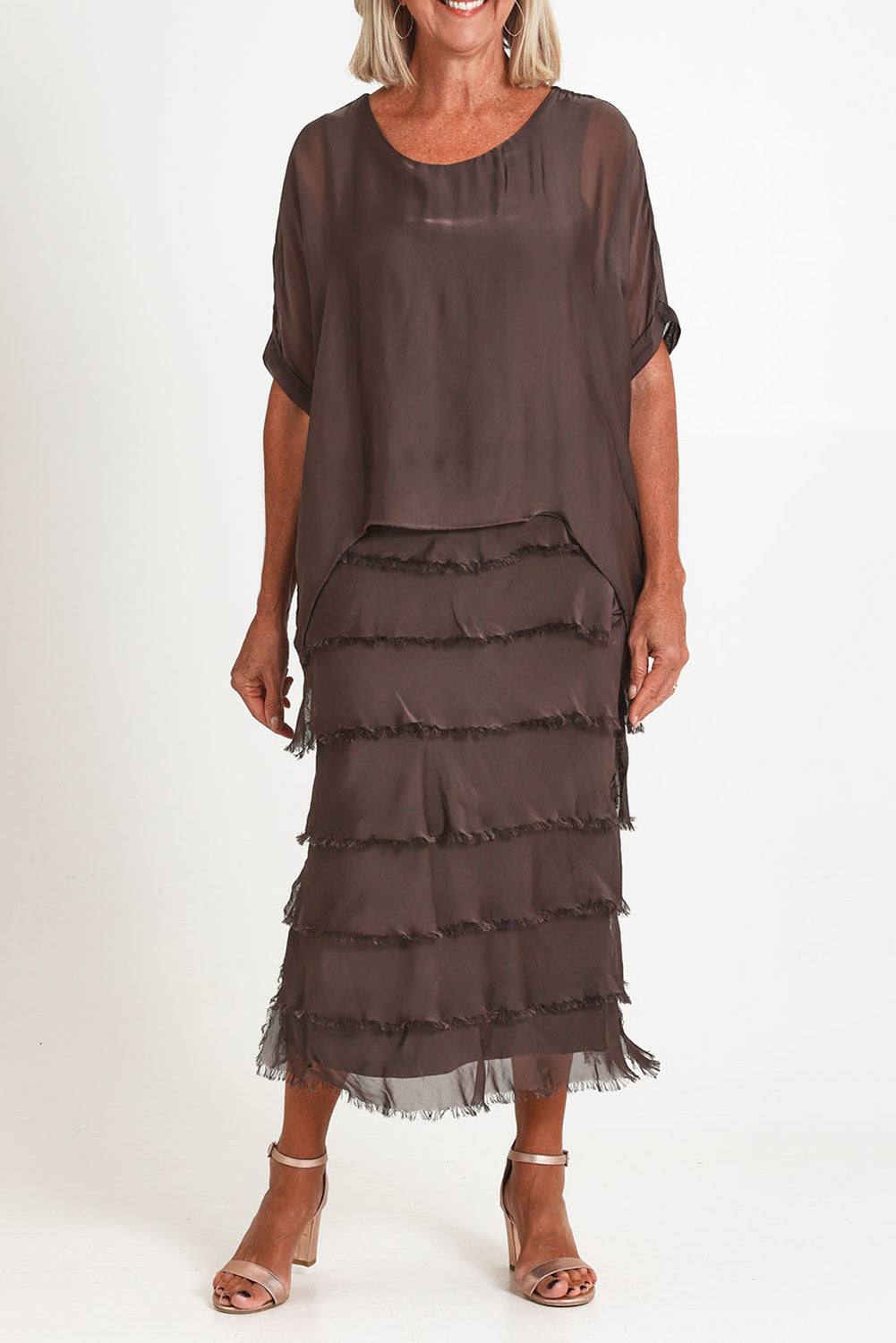 Model Sandy wearing the Silk Blend Multi Layers Dress in colour Moro, from the front, cropped image