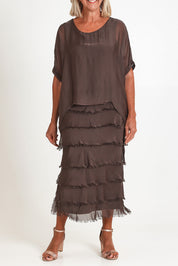 Model Sandy wearing the Silk Blend Multi Layers Dress in colour Moro, from the front, cropped image