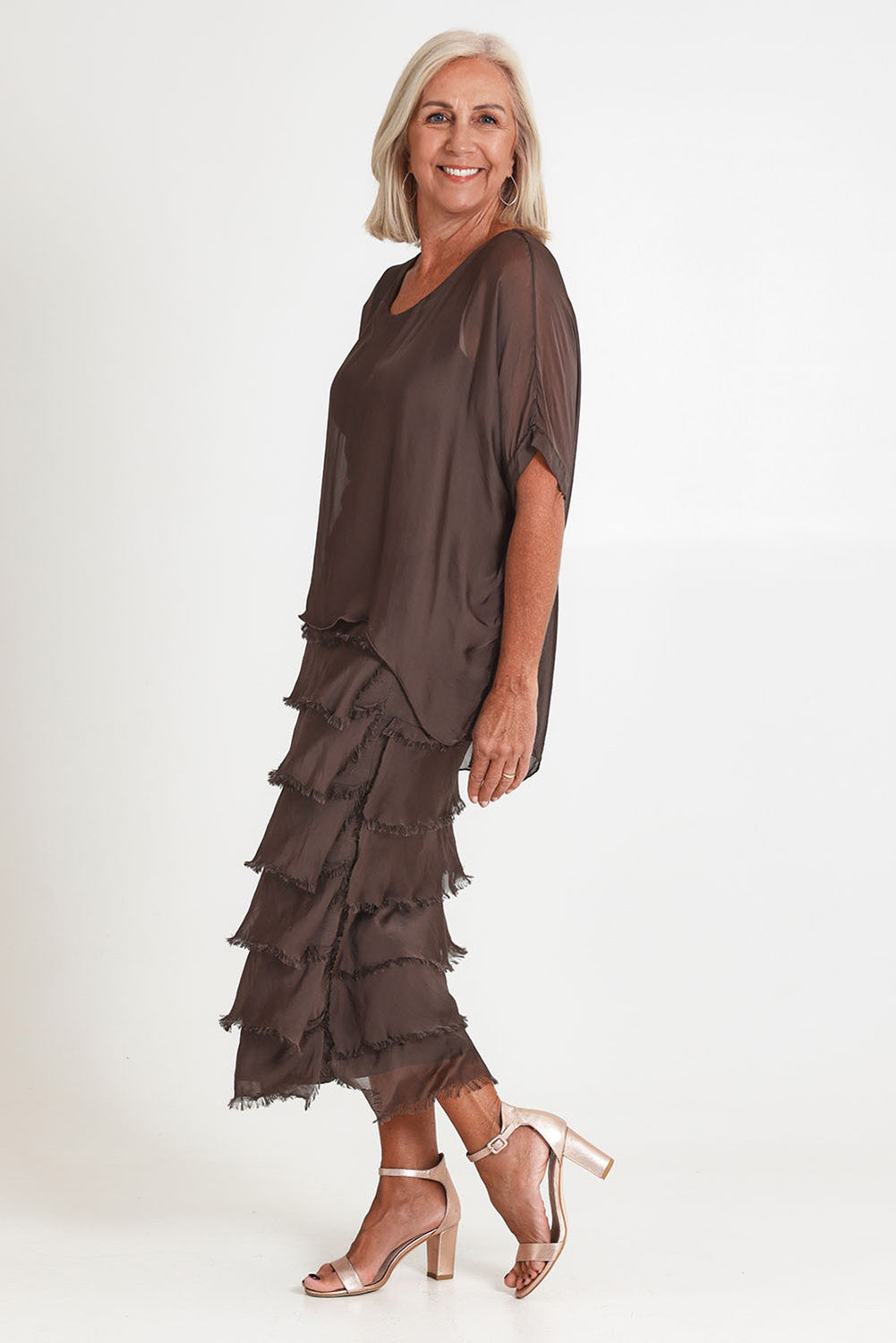 Model Sandy wearing the Silk Blend Multi Layers Dress in colour Moro, from the front, showing the whole outfit