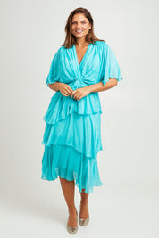 Model Monique wearing the Short Sleeve Silk Dress in colour Aqua (Green), from the front, showing the whole outfit