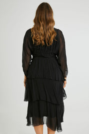 Model Laura wearing the Long Sleeve Silk Dress in colour Black (Black), from the back