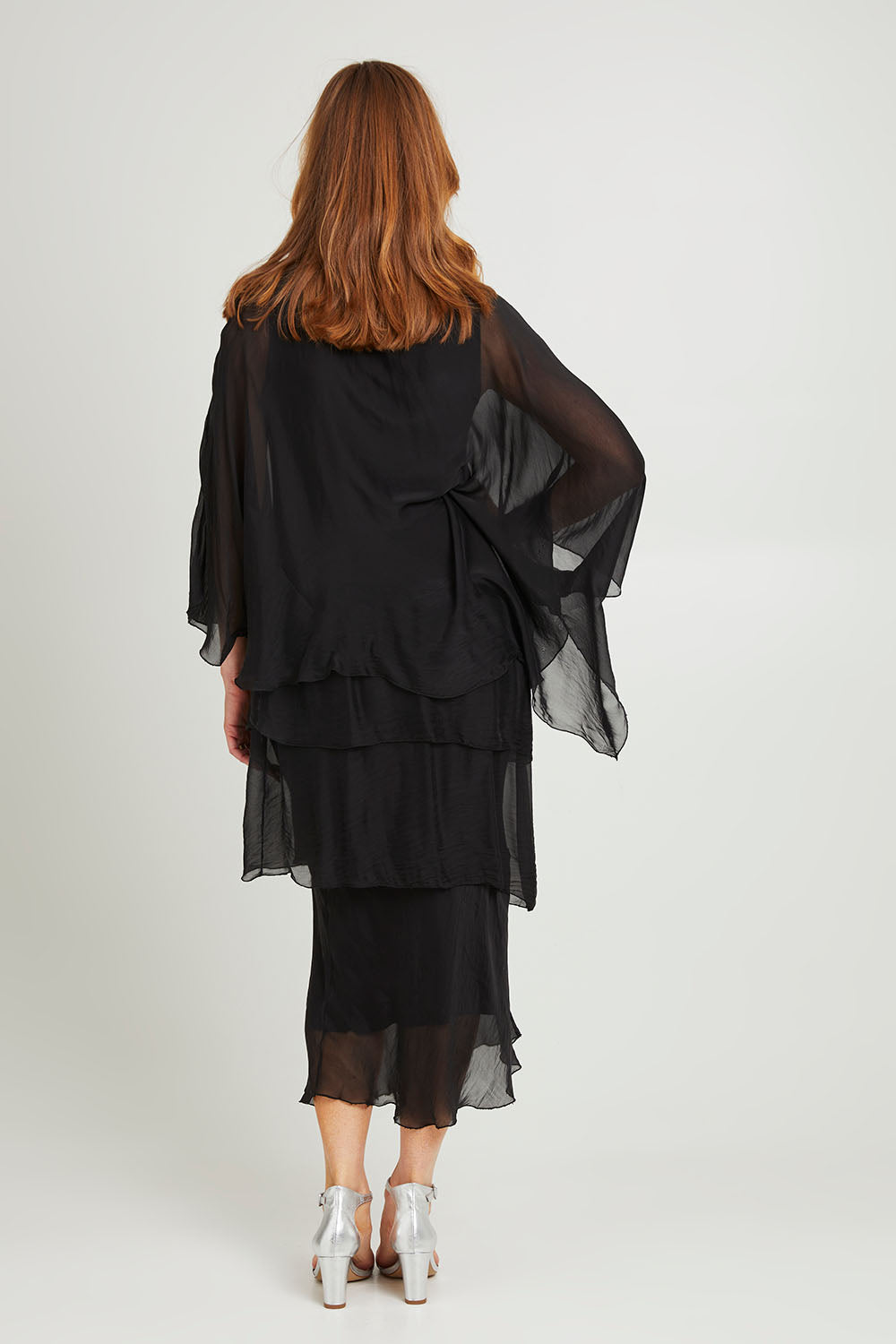 Model Katie wearing the Overlay Silk Dress in colour Black (Black), from the back
