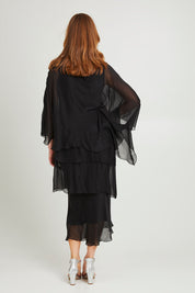 Model Katie wearing the Overlay Silk Dress in colour Black (Black), from the back