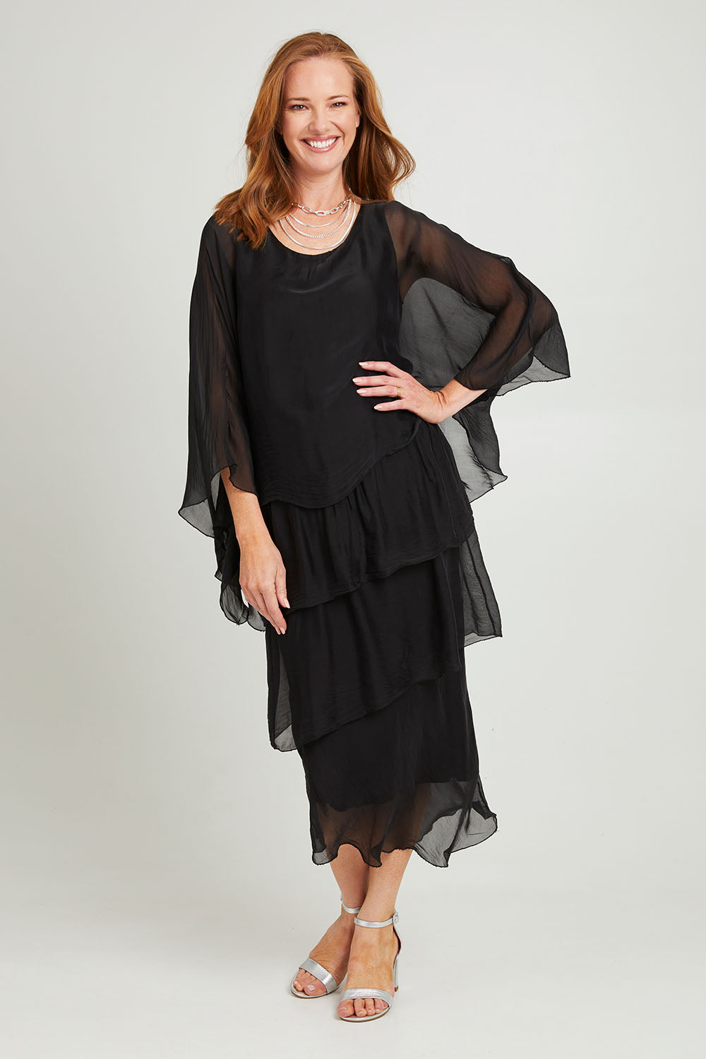 Model Katie wearing the Overlay Silk Dress in colour Black (Black), from the front, showing the whole outfit