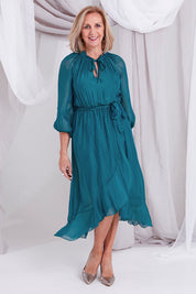 Model Sandy wearing the Frill Tie Neck Dress in colour Teal (Green), from the front, showing the whole outfit