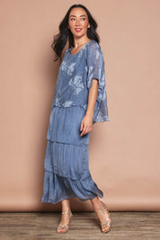 Model Katie wearing the Multi Layer Silk Blend Print Dress in colour Jeansprint (Blue), from the front, showing the whole outfit