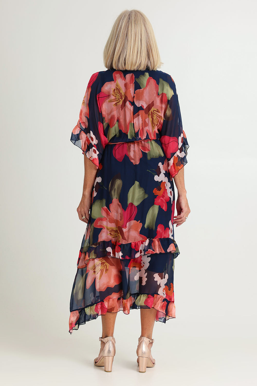 Model Sandy wearing the Frill Sleeve Silk Blend Print Dress in colour Navyprint (Blue), from the back