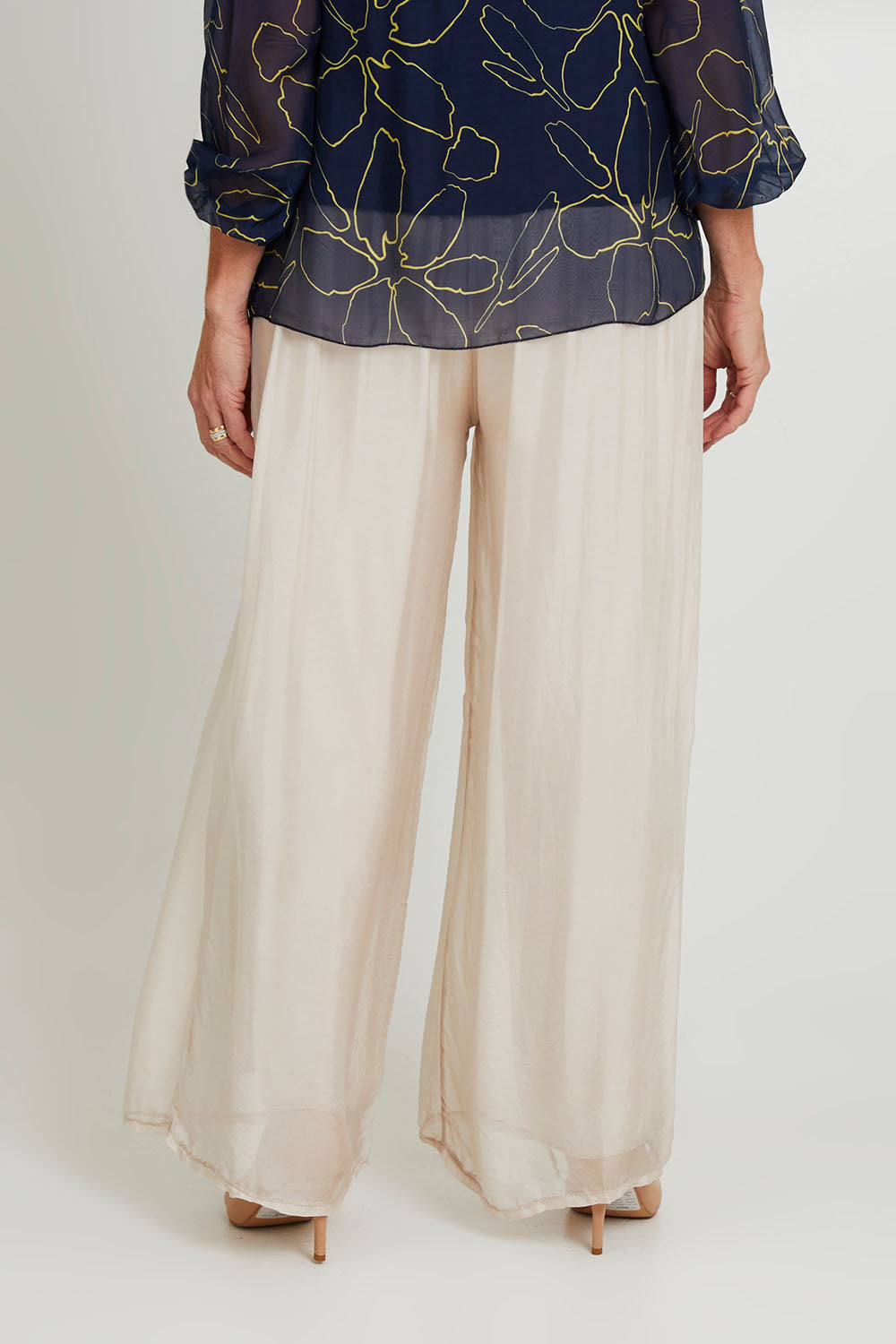 Model Sandy wearing the Silk Pant in colour Beige, from the back