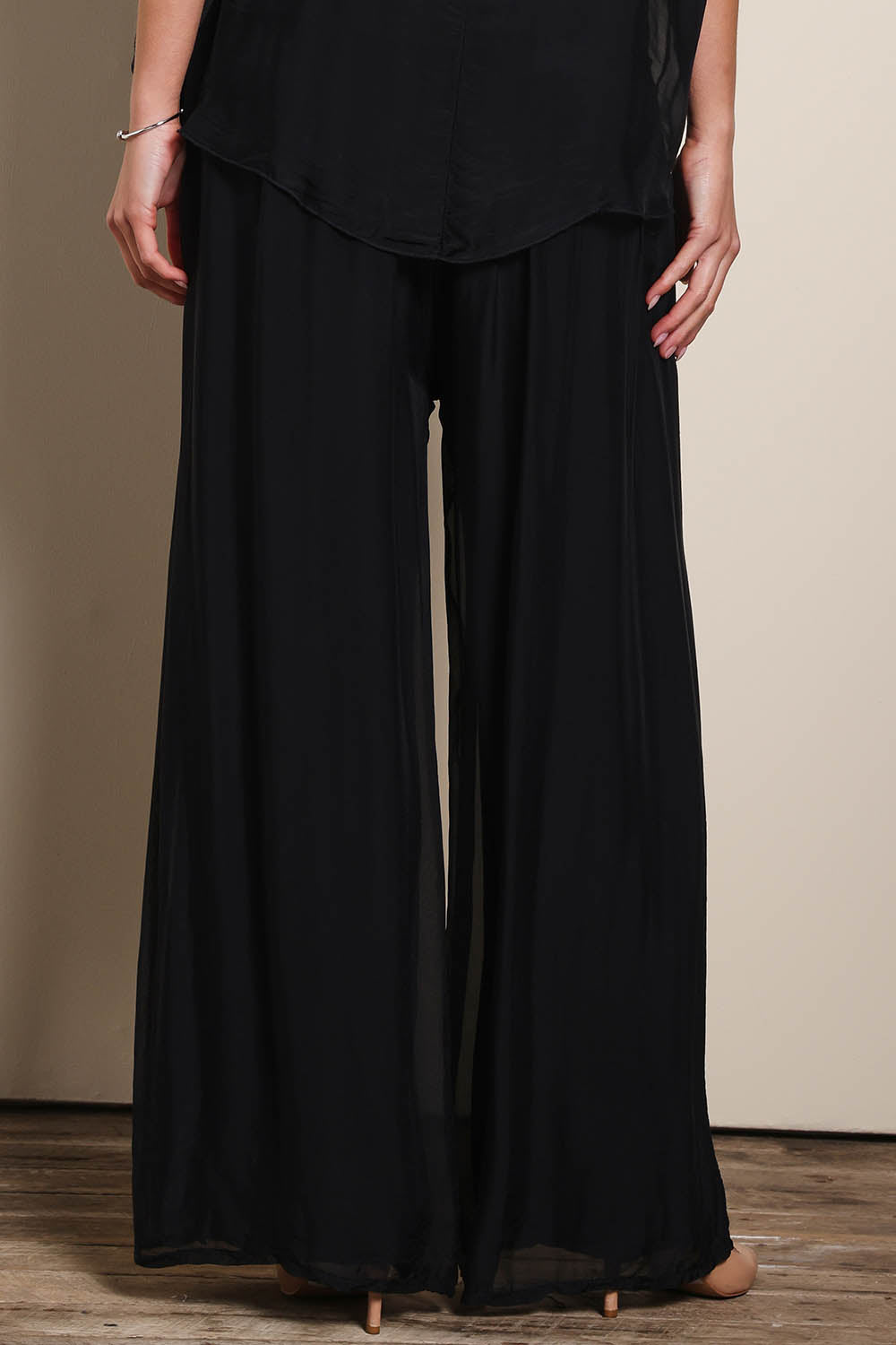 Model Maddiec wearing size 10 of the Silk Pant - Black in colour Black, in a cropped view