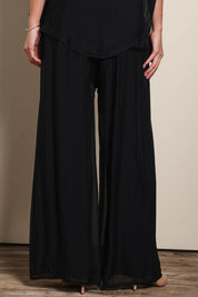 Model Maddiec wearing size 10 of the Silk Pant - Black in colour Black, in a cropped view