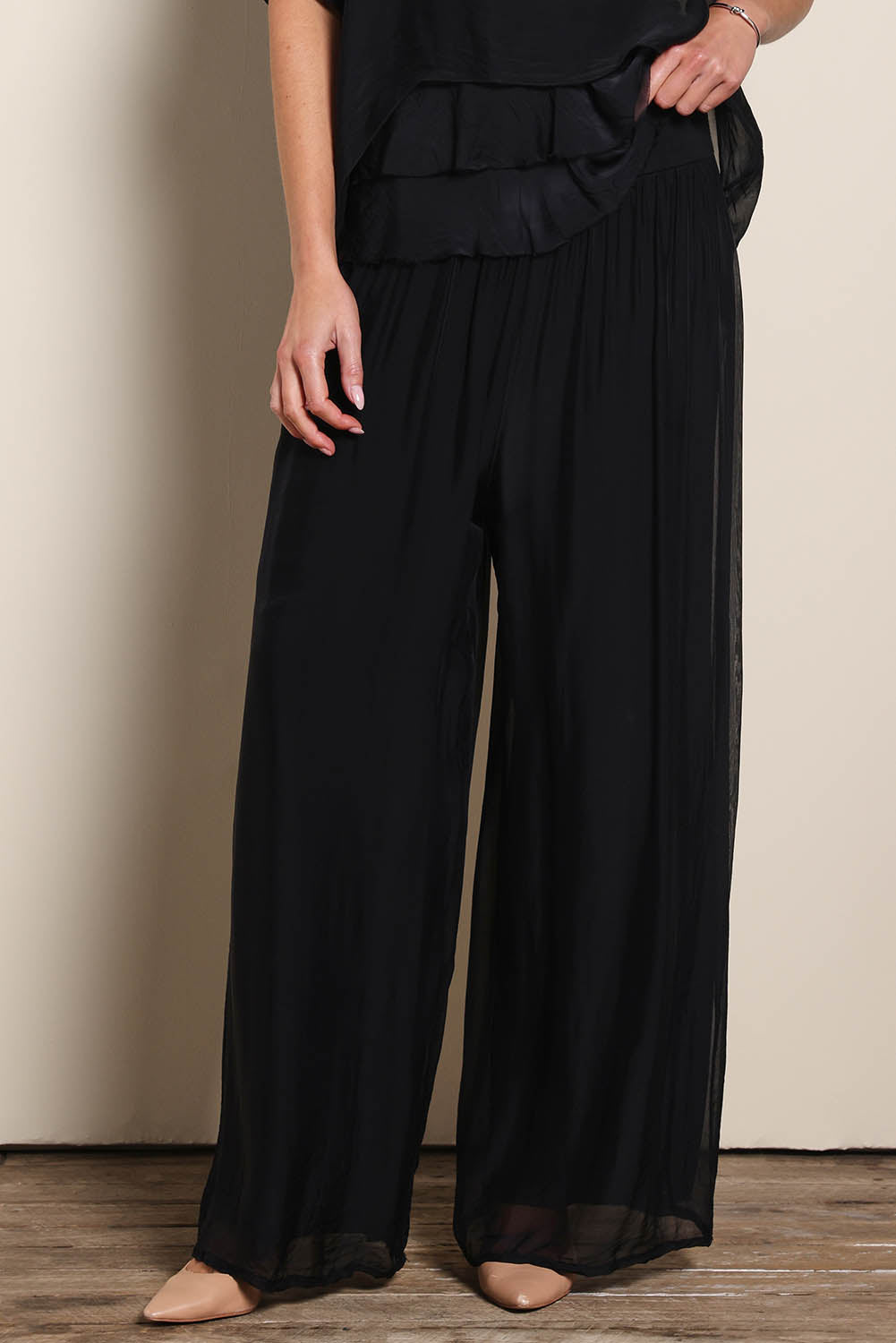 Model Maddiec wearing size 10 of the Silk Pant - Black in colour Black, from the front