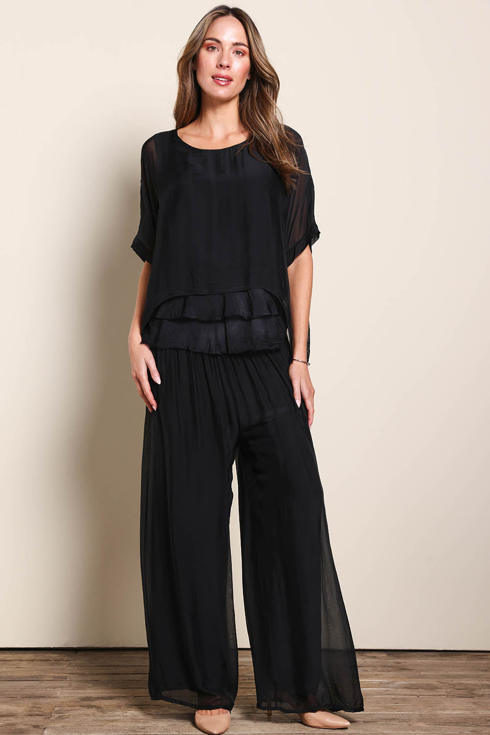 Model Maddiec wearing size 10 of the Silk Pant - Black in colour Black, from the front