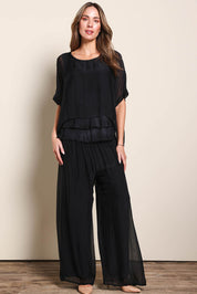 Model Maddiec wearing size 10 of the Silk Pant - Black in colour Black, from the front