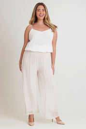 Model Chanel wearing the Silk Pant in colour Ivory, from the front, showing the whole outfit