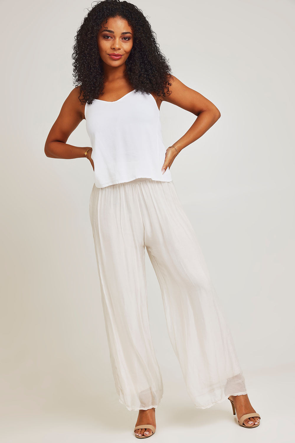 Model Ziara wearing the Silk Pant in colour Ivory, from the front, showing the whole outfit