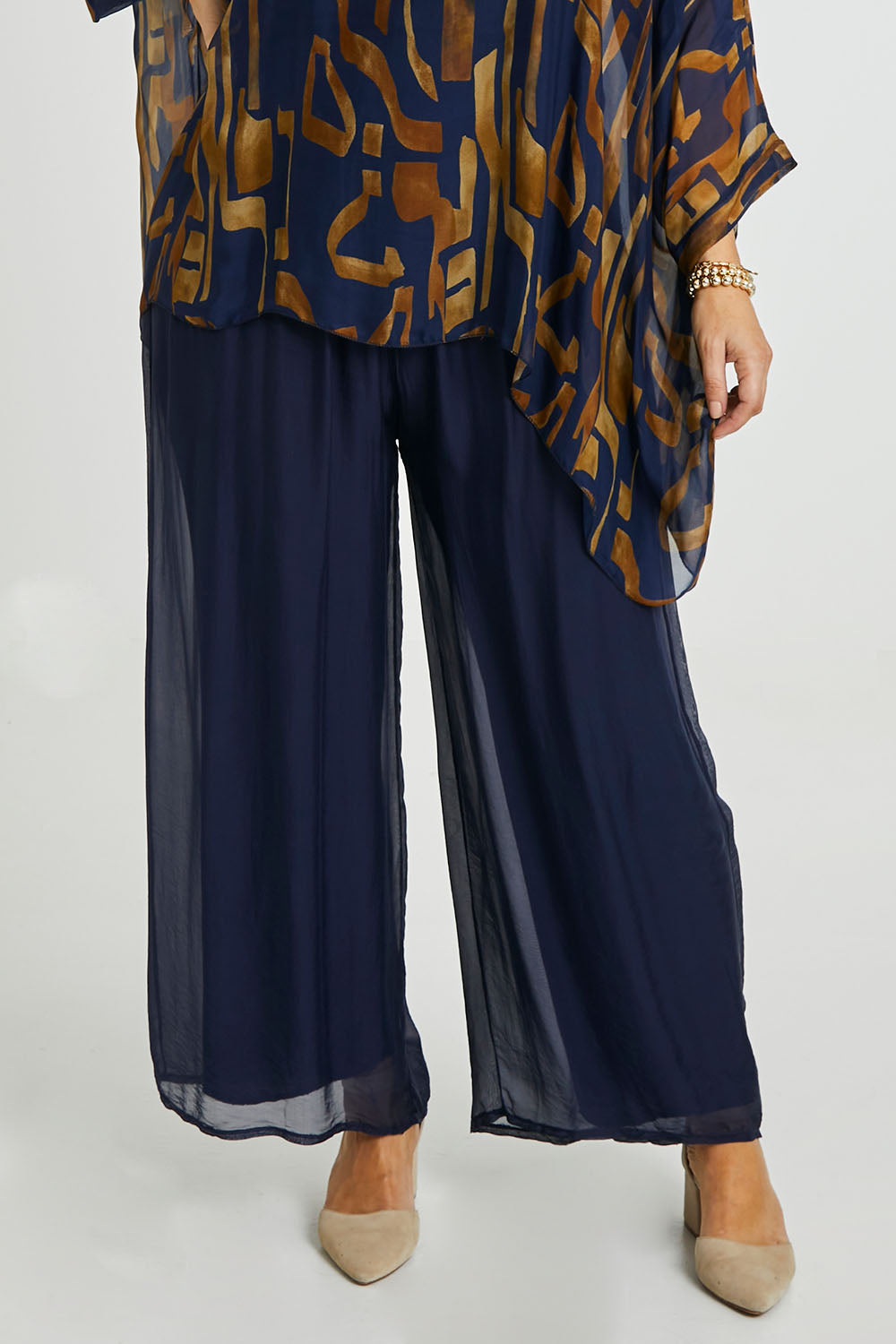 Model Laura wearing the Silk Pant in colour Navy (Blue), from the front, cropped image