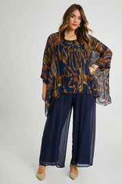 Model Laura wearing the Silk Pant in colour Navy (Blue), from the front, showing the whole outfit